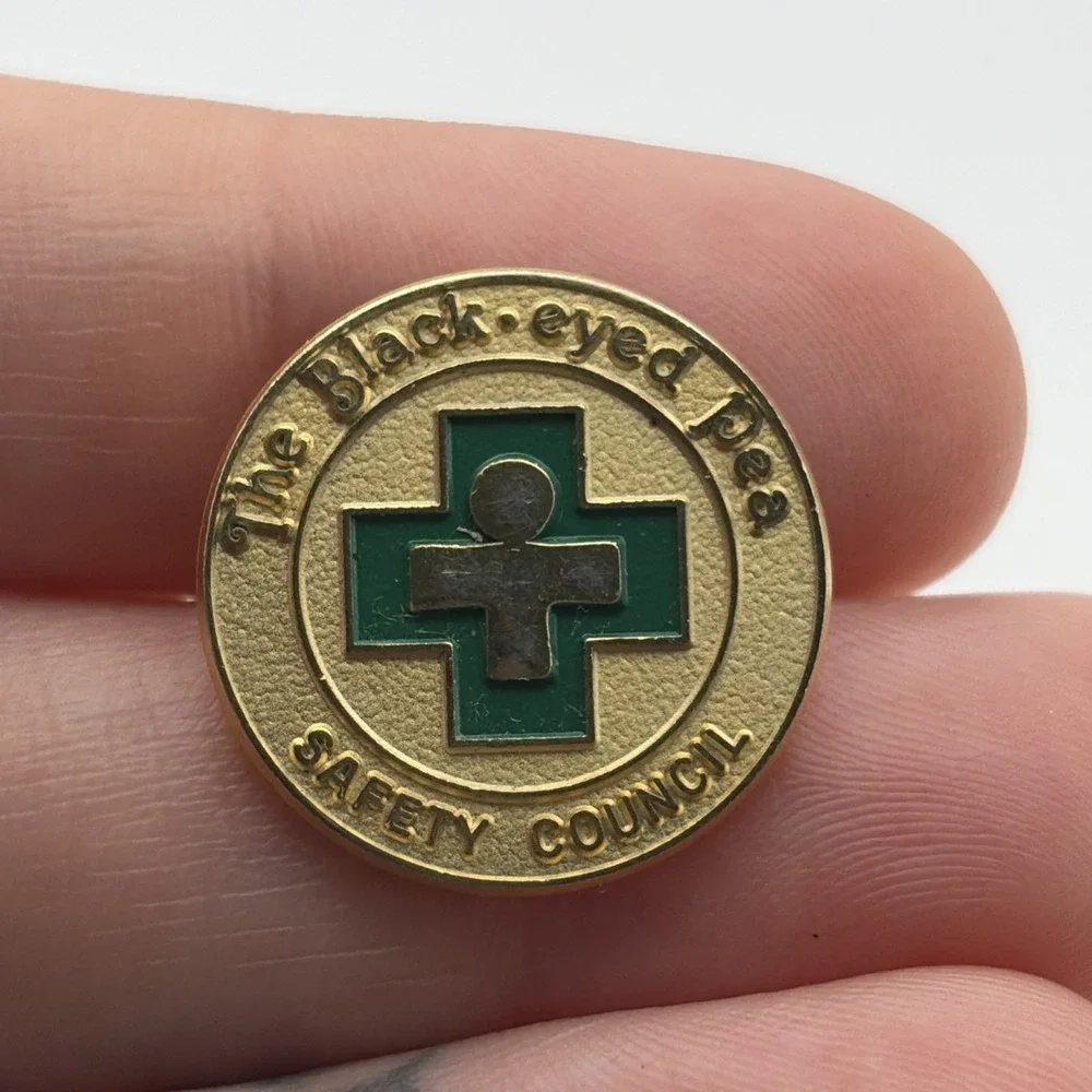 The Black-Eyed Pea Safety Council Green Cross Lapel Hat Pin